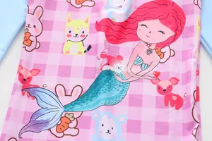 Macro detail view of girls' pink mermaid swimsuit with cute cartoon animal prints