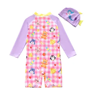 Detail of girls' one-piece swimsuit with cute cartoon animals and matching mermaid cap