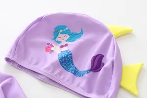 High-quality detailed close-up of cartoon mermaid pattern on purple girls swim cap