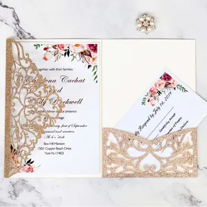 Elegant gold glitter laser-cut wedding invitation set with floral inserts on marble