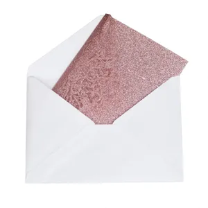 Rose gold glitter greeting card with white envelope for elegant wedding invitations.