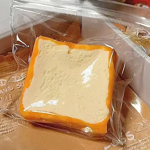 Macro view of food-grade silicone toast squishy toy in a protective clear plastic bag