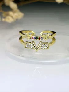 Close-up of gold-plated V letter open ring with sparkling multicolor zircons