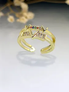 Close-up view of a luxury gold V-letter ring with colorful and clear zirconia stone inlay