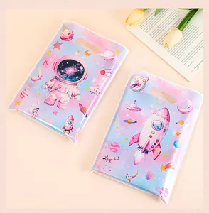 Detail view showing space-themed astronaut and rocket print gift bags for kids' parties