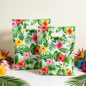 Vibrant tropical floral party gift bags with Hawaiian hibiscus and palm leaf patterns.