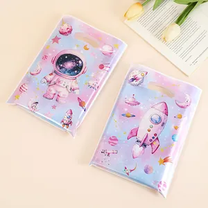 Two pearlescent space-themed gift bags with astronaut and rocket prints for parties