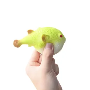 Close-up of a pufferfish squeeze toy held in hand showing its soft and bumpy texture