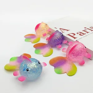 Group of four glittery goldfish squishy toys for stress relief, slow rising colorful toys