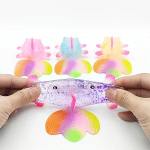 Close-up detail of a stretchy purple goldfish squeeze toy being pulled by hands for stress relief