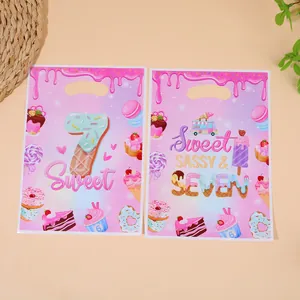 Two pink donut themed candy gift bags for 7th birthday party with Sweet Seven design