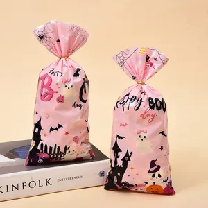 Pink Halloween candy gift bags with ghost and pumpkin prints and gold twist ties