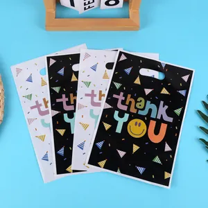 Set of festive black and white Thank You gift bags with smiley face and hat prints