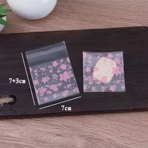 Detailed view of pink cherry blossom semi-transparent self-adhesive bags for cookie packaging