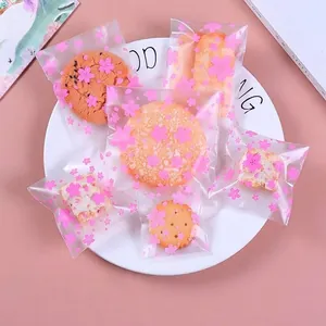 Close-up detail of frosted pink cherry blossom snack bags for cookies and candy packaging.