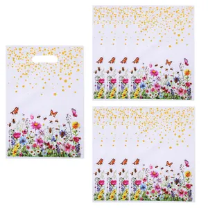 Vibrant wildflower and butterfly print party gift bags with elegant gold glitter accents