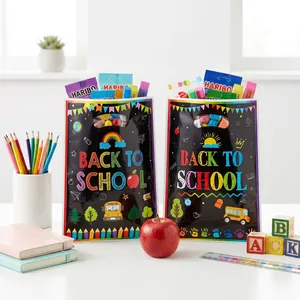 Colorful Back to School blackboard style gift bags with stationery props in macro view