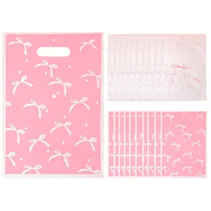 Pink pearlescent gift bags with white bow patterns for party favors and candy treats.