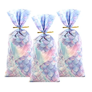 Detailed view of mermaid scale print OPP treat bags with gold twist ties.