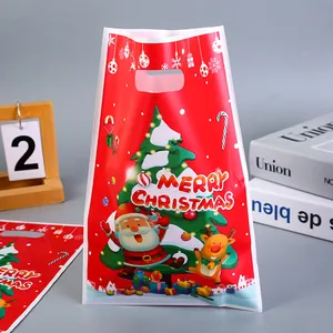 Sac cadeau de Noël rouge festif avec le Père Noël et un renne pour les friandises