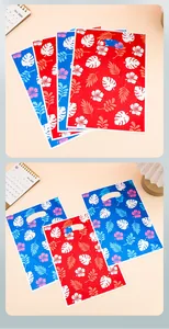 Details of Hawaiian hibiscus and monstera leaf prints on colorful plastic gift bags
