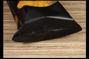Macro view of the flat bottom seal on a black and yellow Halloween pumpkin packaging bag