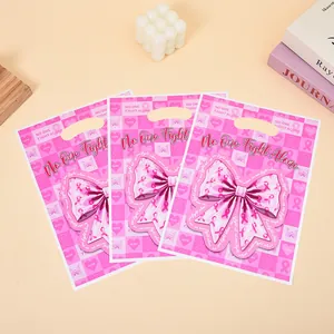 Three pink gift bags with large bow prints and inspirational No One Fight Alone text