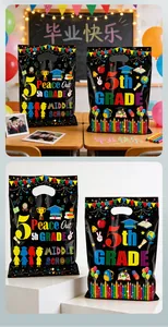 Colorful graduation party gift bags with 5th Grade school theme patterns and handles