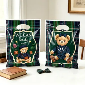 Detailed view of British style teddy bear gift bags featuring a classic green plaid pattern