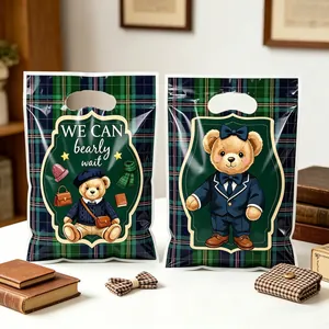 Detailed view of British style bear party favor bags with green plaid pattern