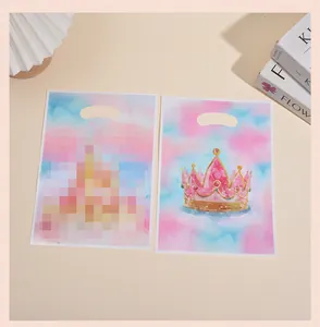 Detail view of pink watercolor gift bags with golden crown and die-cut handles.