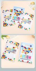 Close-up of colorful Autism Awareness puzzle pattern gift bags for parties and shopping.
