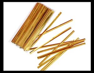 Detailed macro view of metallic gold twist ties for decorative gift bag sealing