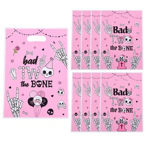 Pink Halloween skeleton gift bags with Bad Two the Bone print for party favors