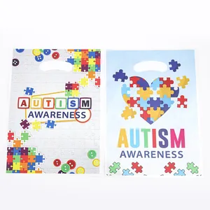 Autism awareness gift bags with puzzle piece heart and patterns for party favors
