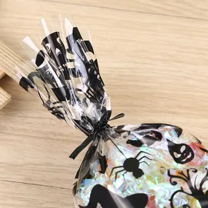 Durable black twist ties for sealing decorative Halloween treat bags on wooden surface