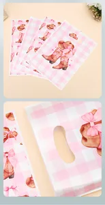 Macro detail of pink gingham party gift bags featuring cowboy boot and bow patterns