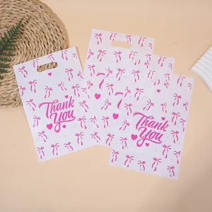 Sacs cadeaux en film de perles blanches avec nœuds roses et texte Thank You pour fêtes