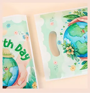 Close-up detail of eco-friendly Earth Day theme plastic bags with cute planet illustrations.