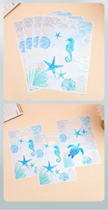 Macro view of watercolor ocean themed plastic gift bags showing sea life patterns
