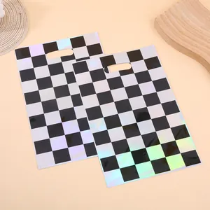 Holographic black and white checkerboard gift bags with die-cut handles for birthday parties