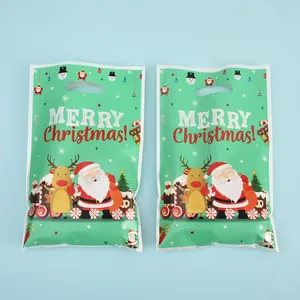 Two green pearly film Christmas gift bags featuring cartoon Santa and reindeer design