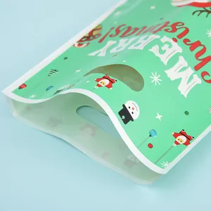 Festive green pearlescent Christmas gift bag featuring Santa and snowman patterns