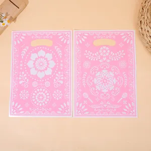 Elegant pink plastic gift bags with intricate white floral mandala patterns and handles.