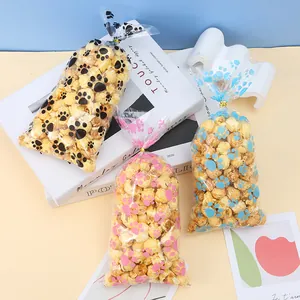 Bolsas transparentes para alimentos con huellas de perro de colores y lazos dorados