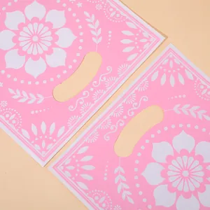 Premium pink floral party plastic gift bags with die-cut handles for holiday gift packaging