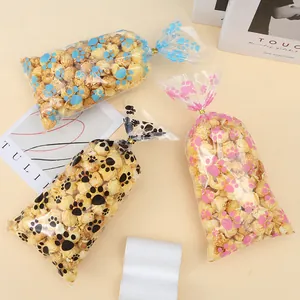 Bolsas de caramelos OPP transparentes con huellas de perro y lazos dorados