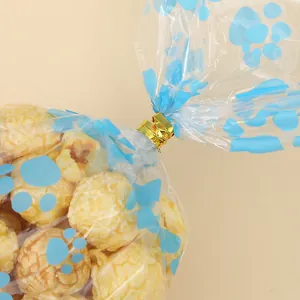 Bolsa de embalaje transparente OPP con huellas azules de perro y cierre de lazo dorado
