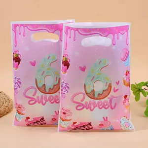 Pink pearlescent party gift bags with donut print and Sweet text for 6th birthday candy