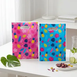 Tropical summer party gift bags with hibiscus and palm leaf patterns for celebrations